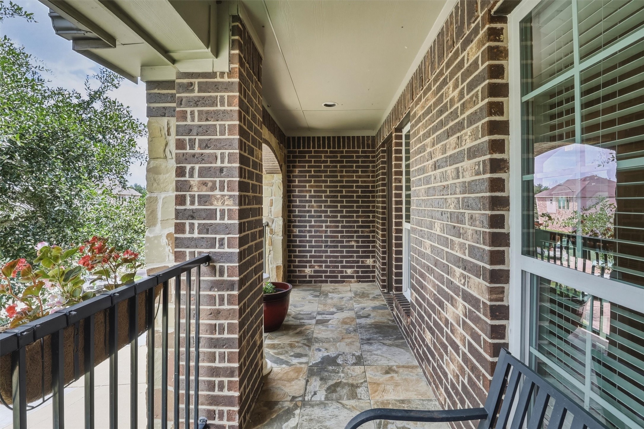 3219 Cotton Ranch Drive Katy, TX 77494 - Photo 40 of 45 Finished with attractive tile flooring, classic brick accents, recessed lighting, and elegant wrought-iron railings, this peaceful retreat offers a comfortable place to enjoy your morning coffee, unwind with a favorite book, or relax in the evening while overlooking the surrounding neighborhood.