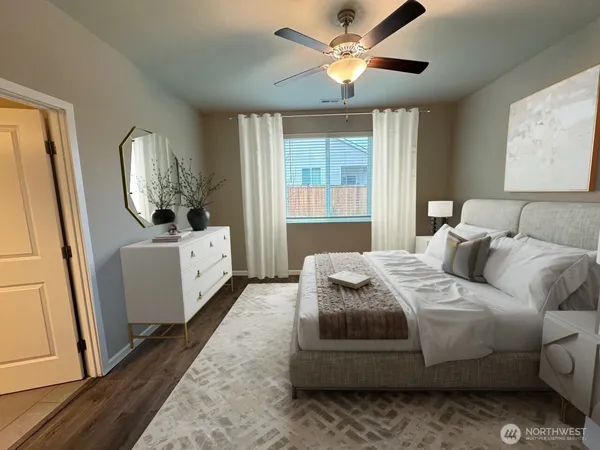 a bedroom with a bed chandelier and a window