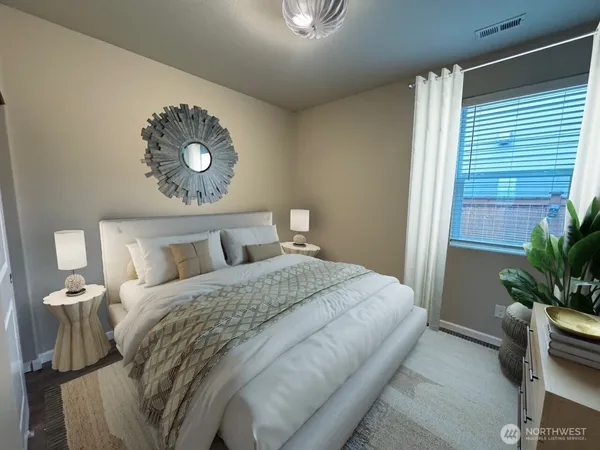 a bedroom with a bed and a potted plant
