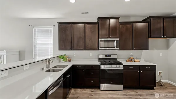 a kitchen with a sink appliances and cabinets