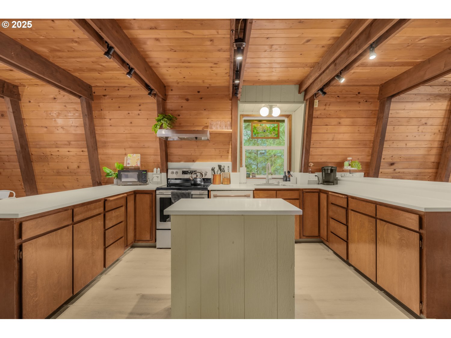 21760 East Tree Swallow Lane Rhododendron, OR 97049 - Photo 13 of 32 a kitchen with stainless steel appliances kitchen island granite countertop a stove a sink and white cabinets