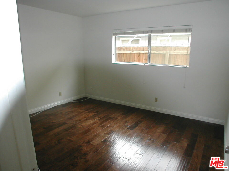 3745 Keystone Avenue, Unit 3 Los Angeles, CA 90034 - Photo 11 of 14 an empty room with wooden floor and windows