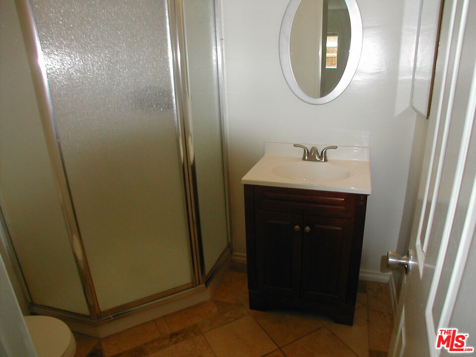 3745 Keystone Avenue, Unit 3 Los Angeles, CA 90034 - Photo 12 of 14 a bathroom with a sink and a mirror