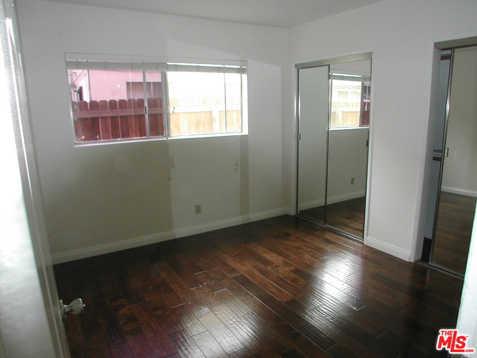 3745 Keystone Avenue, Unit 3 Los Angeles, CA 90034 - Photo 13 of 14 an empty room with wooden floor and windows