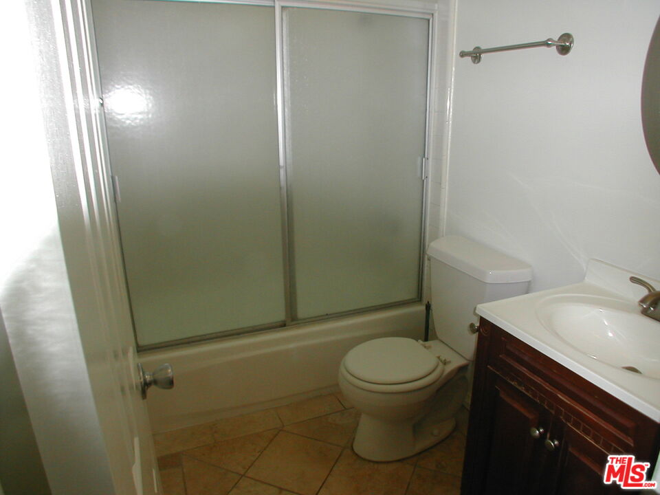 3745 Keystone Avenue, Unit 3 Los Angeles, CA 90034 - Photo 14 of 14 a white toilet sitting next to a bathroom sink