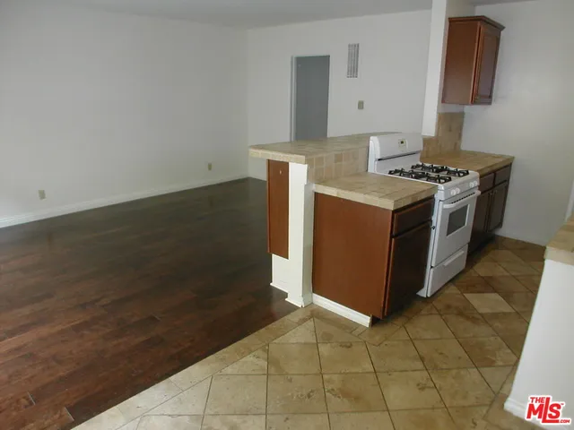 a kitchen with stainless steel appliances a stove a refrigerator and a cabinets