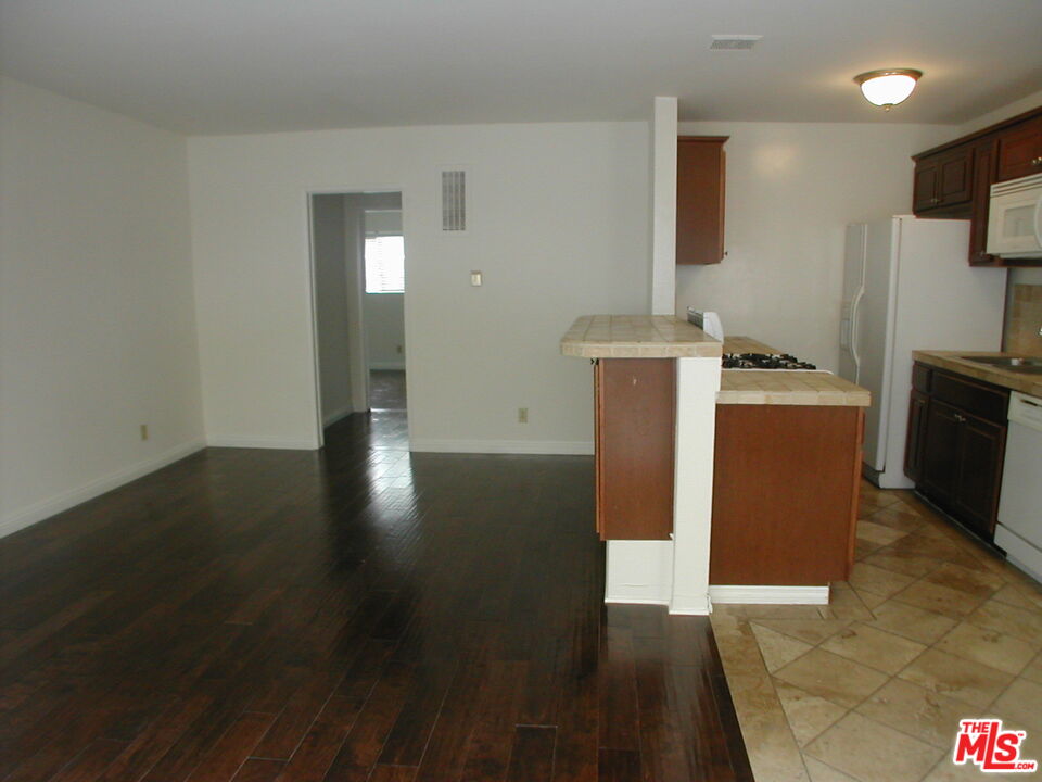 3745 Keystone Avenue, Unit 3 Los Angeles, CA 90034 - Photo 3 of 14 a view of a kitchen with fridge and wooden floor