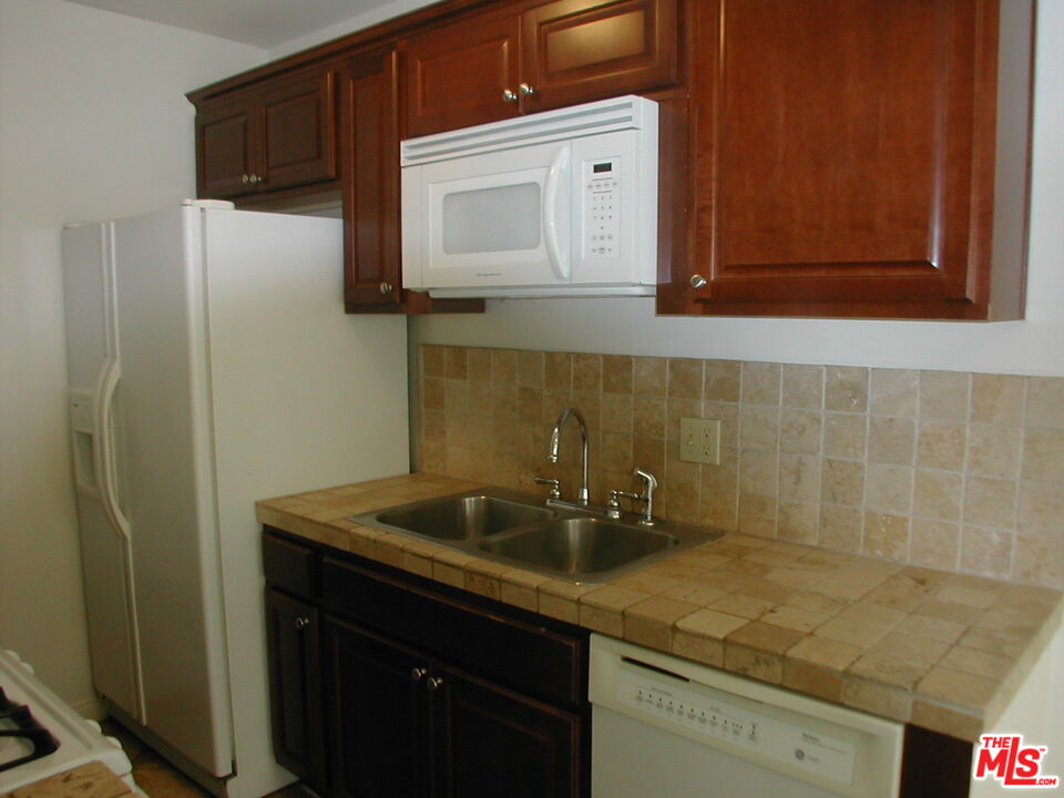 3745 Keystone Avenue, Unit 3 Los Angeles, CA 90034 - Photo 10 of 14 a sink a refrigerator and cabinets