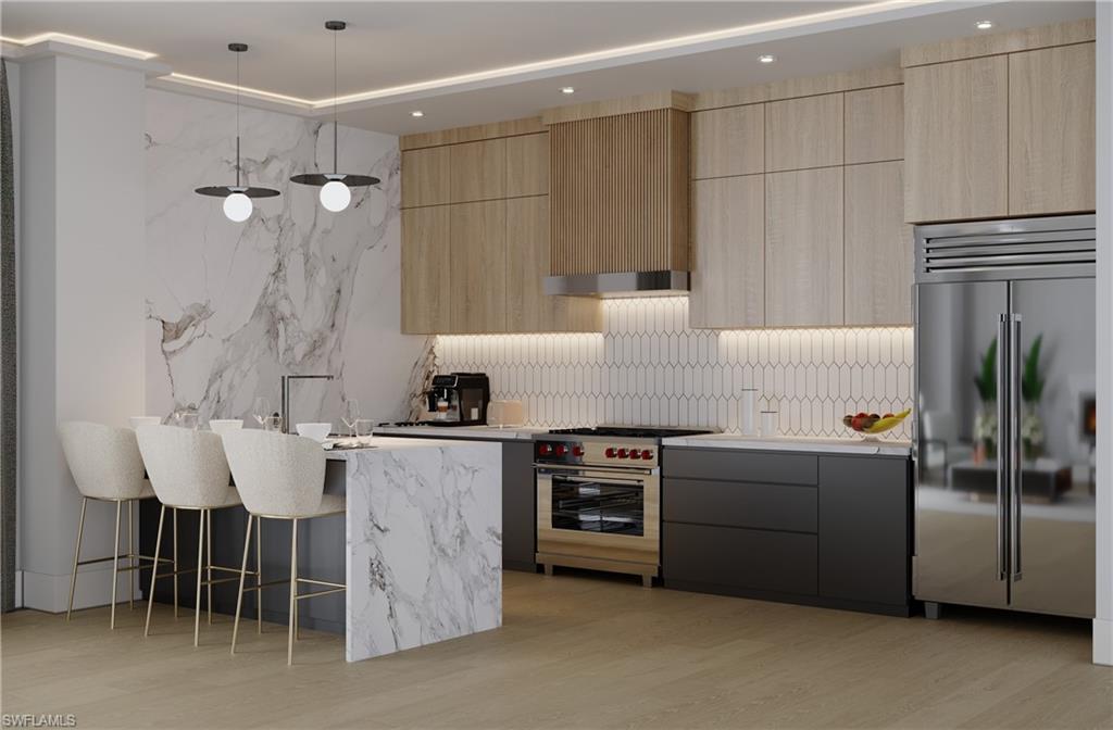 a kitchen with stainless steel appliances granite countertop a sink stove and refrigerator