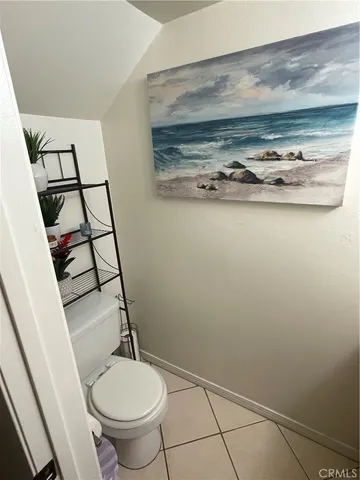 a bathroom with a toilet and a mirror