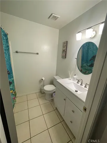 a bathroom with a double vanity sink mirror and toilet