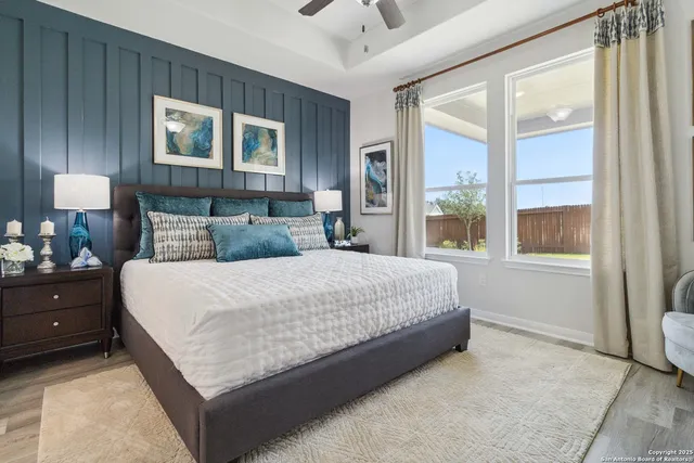 a bedroom with a large bed and a large window