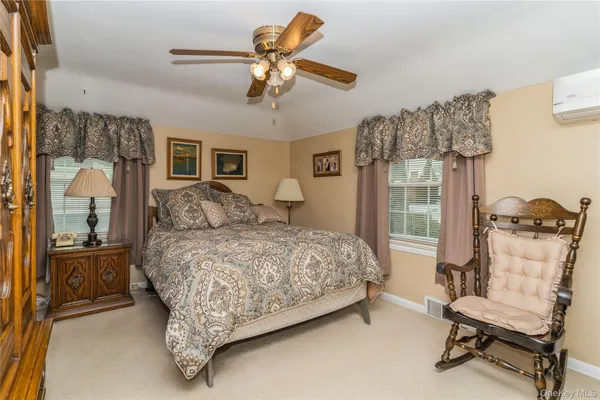 a bedroom with a bed and a chair