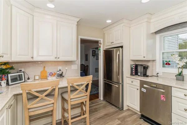 a kitchen with stainless steel appliances a refrigerator stove microwave and cabinets