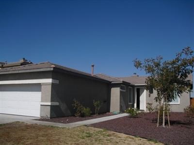 11772 Justine Way Adelanto, CA 92301 - Photo 1 of 1 a front view of a house with a yard