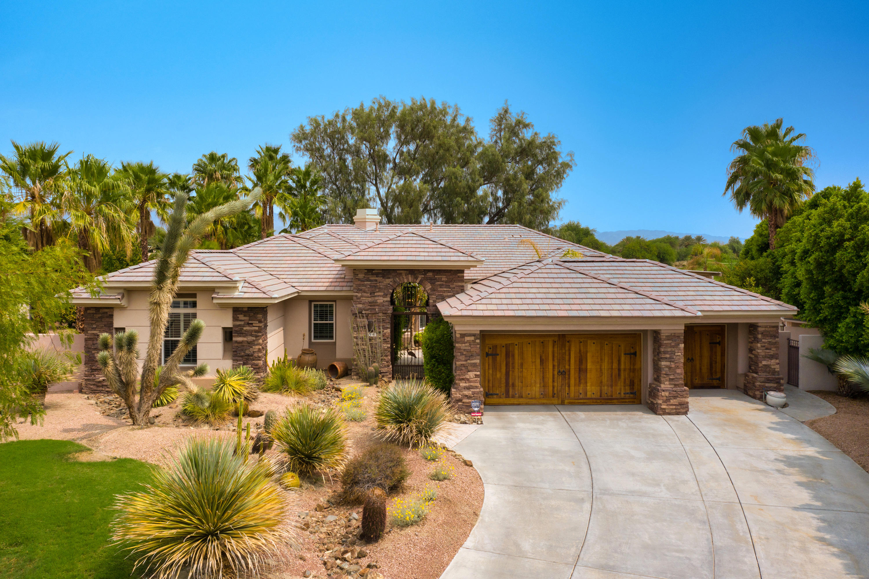 a front view of a house with a garden