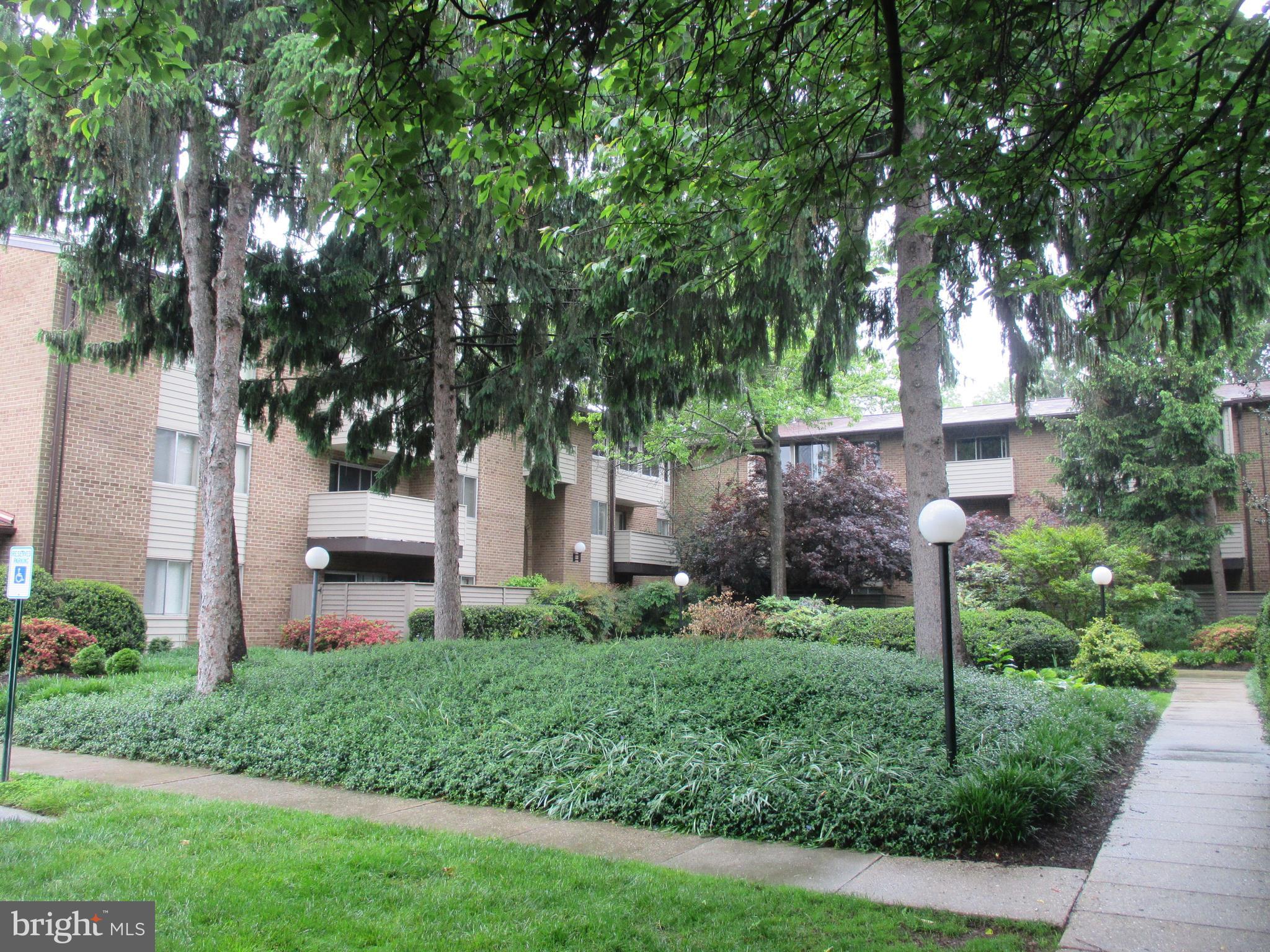 19317 Club House Road, Unit 302 Gaithersburg, MD 20886 - Photo 2 of 18 a view of a house with a yard and tree s