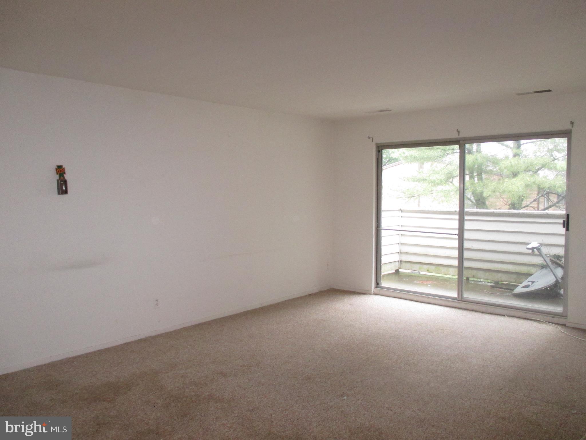 19317 Club House Road, Unit 302 Gaithersburg, MD 20886 - Photo 4 of 18 a view of an empty room with a window