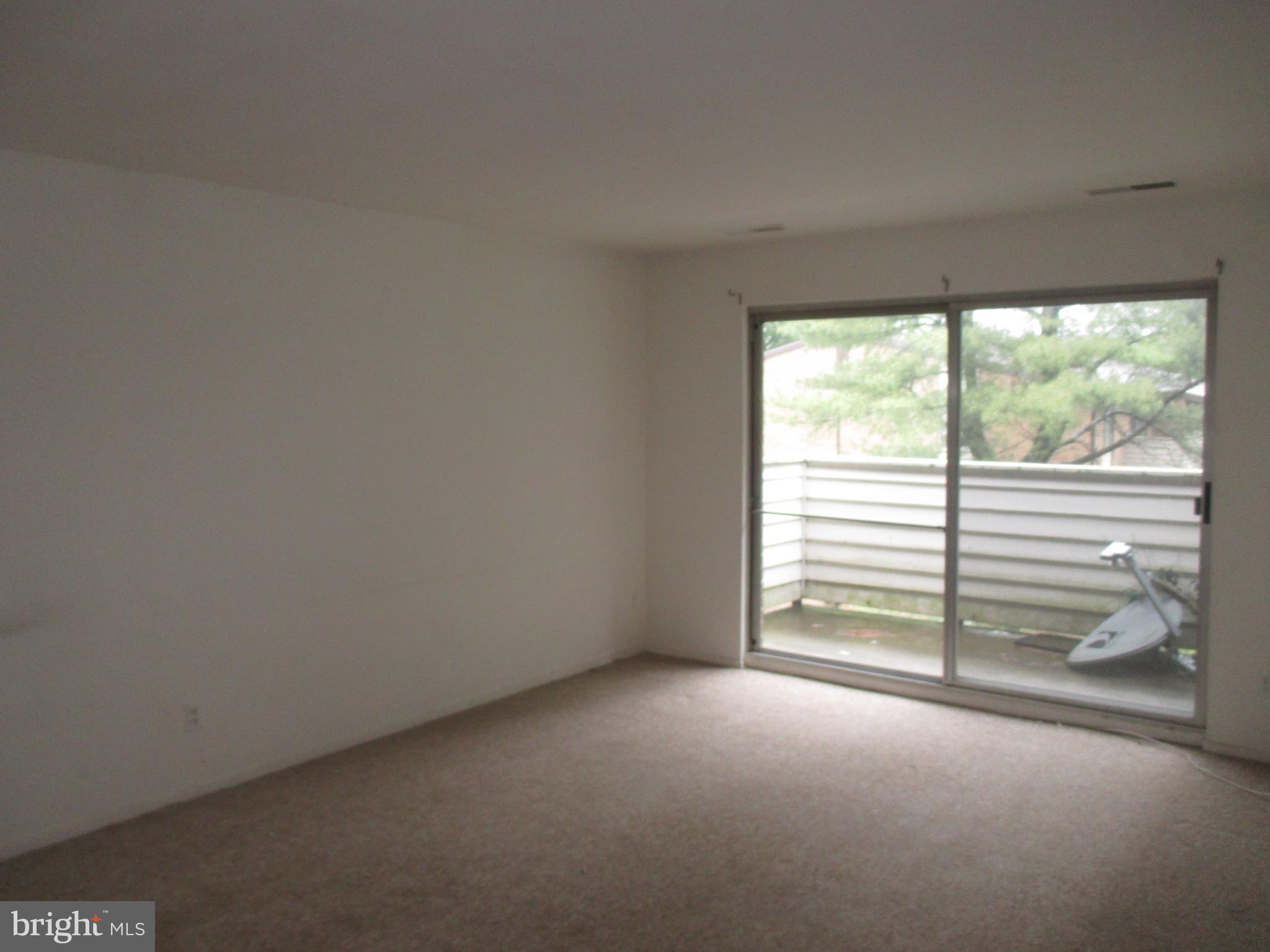 19317 Club House Road, Unit 302 Gaithersburg, MD 20886 - Photo 5 of 18 a view of empty room with stairs and balcony