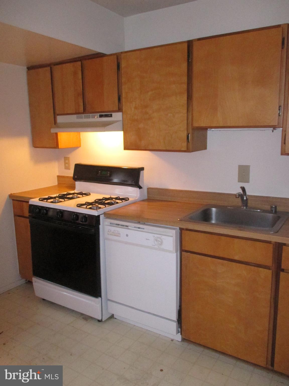 19317 Club House Road, Unit 302 Gaithersburg, MD 20886 - Photo 9 of 18 a kitchen with stainless steel appliances a stove a microwave a sink and cabinets