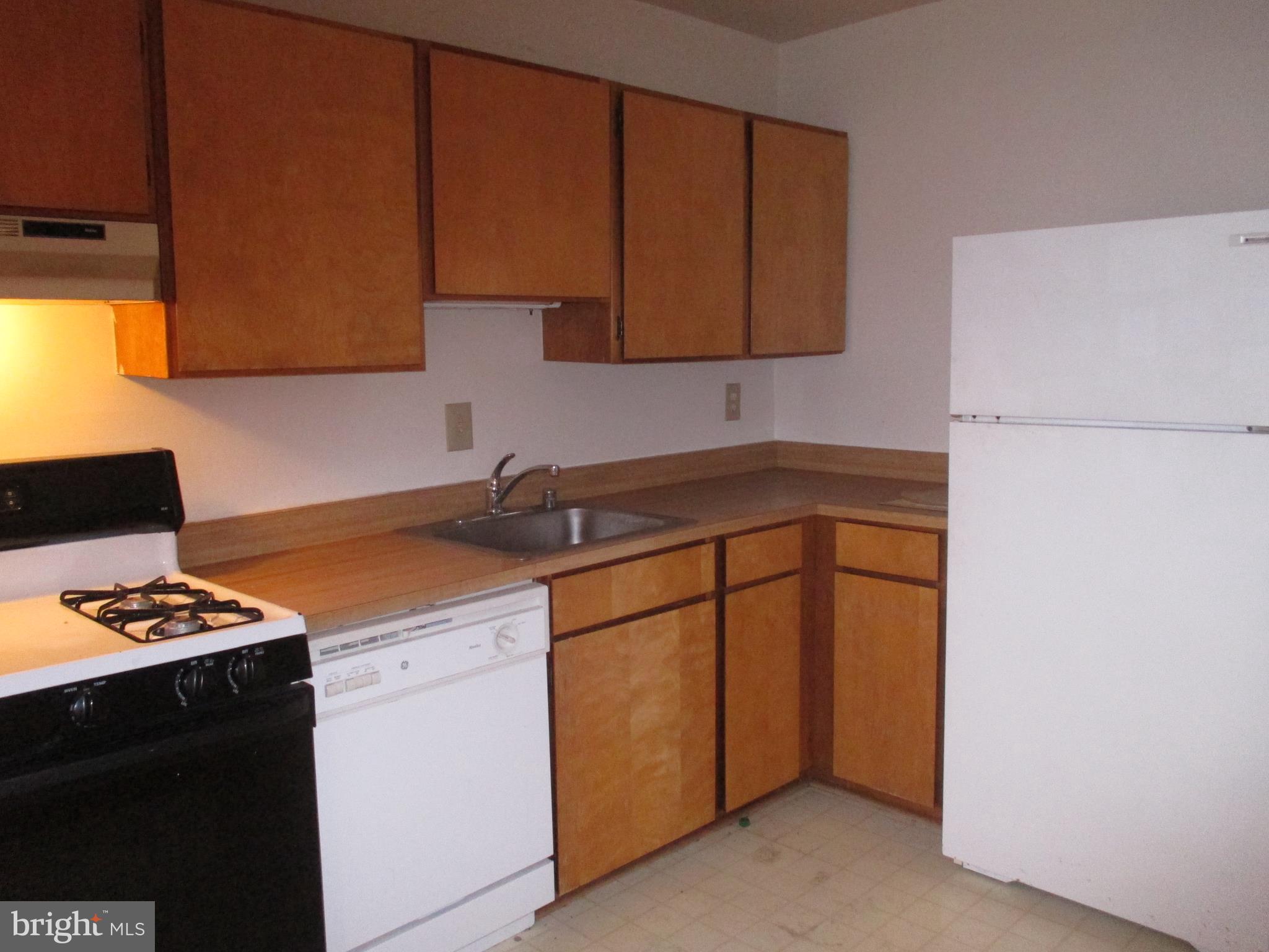 19317 Club House Road, Unit 302 Gaithersburg, MD 20886 - Photo 10 of 18 a kitchen with stainless steel appliances granite countertop a sink stove and cabinets