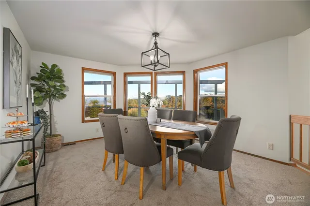 a dining room with furniture a chandelier and wooden floor
