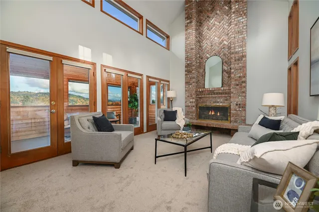 a living room with furniture and a floor to ceiling window