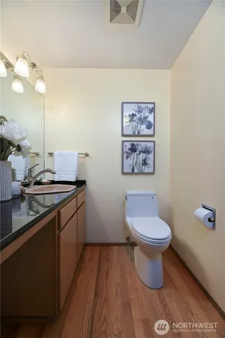 a bathroom with a toilet a sink and mirror