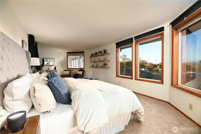 a bed sitting in a bedroom next to a window