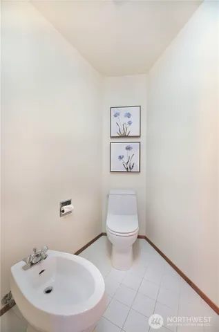 a white toilet sitting next to a white sink