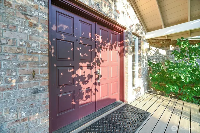 a view of a house with a door and wooden floor