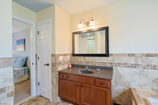 a bathroom with a sink vanity and mirror