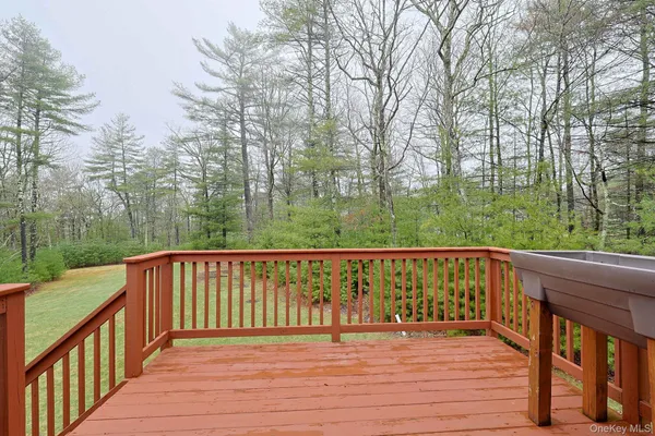 a view of deck with a yard and wooden fence