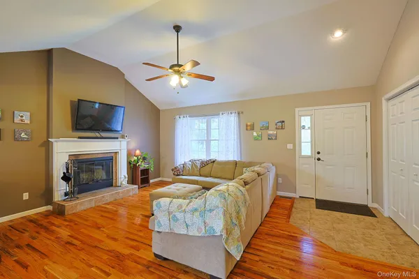 a living room with furniture a fireplace and a flat screen tv