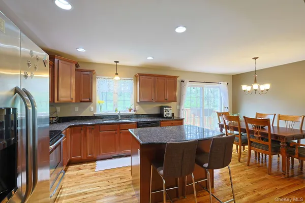 a kitchen with granite countertop a dining table chairs and granite counter tops