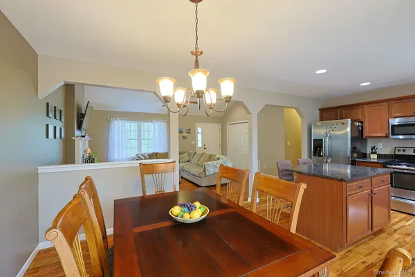 a view of a dining room with furniture and a chandelier