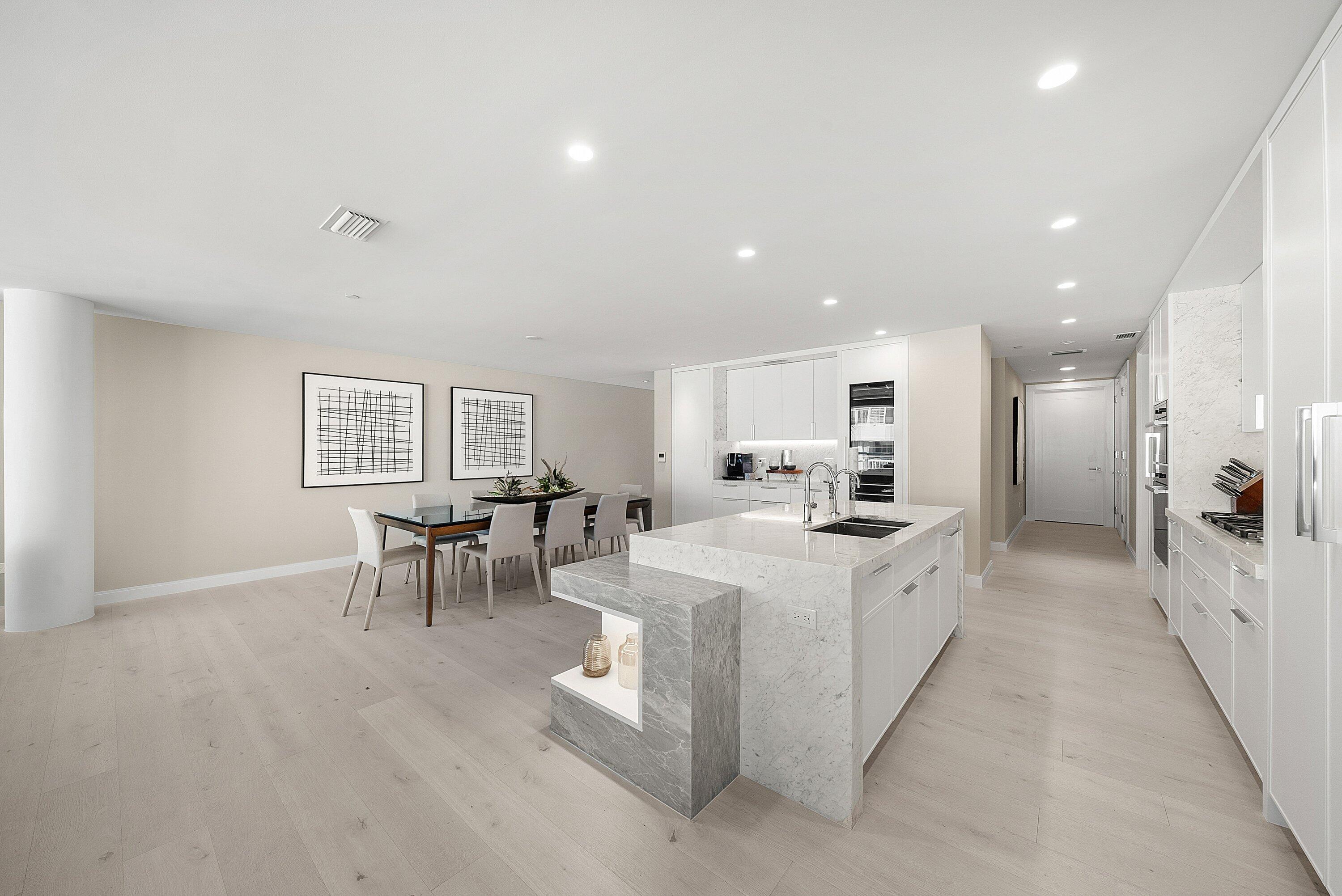 3550 South Ocean Boulevard, Unit 7C South Palm Beach, FL 33480 - Photo 13 of 66 a large white dining hall with stainless steel appliances granite countertop a sink and a refrigerator