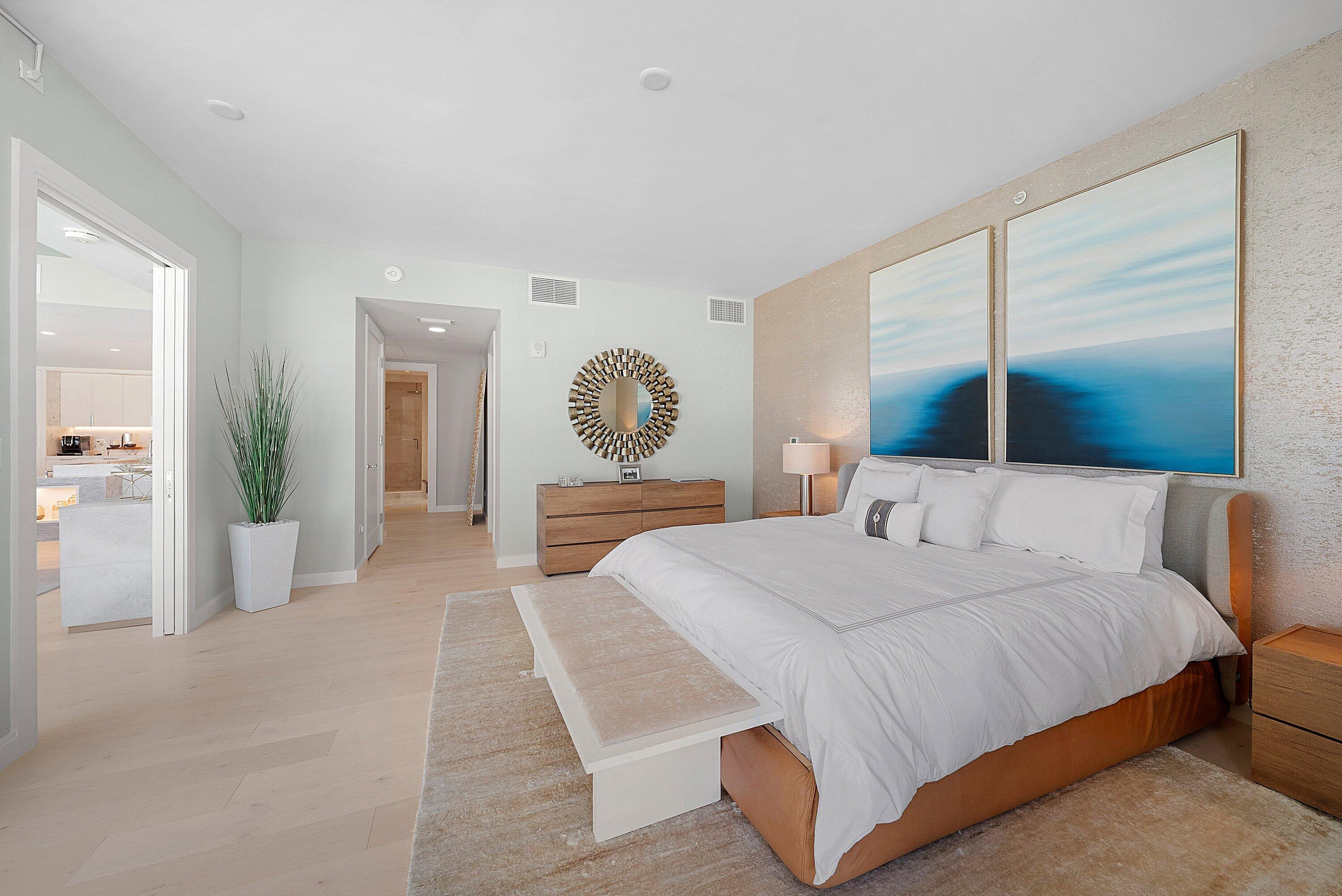 3550 South Ocean Boulevard, Unit 7C South Palm Beach, FL 33480 - Photo 21 of 66 a bedroom with a large bed and a chandelier