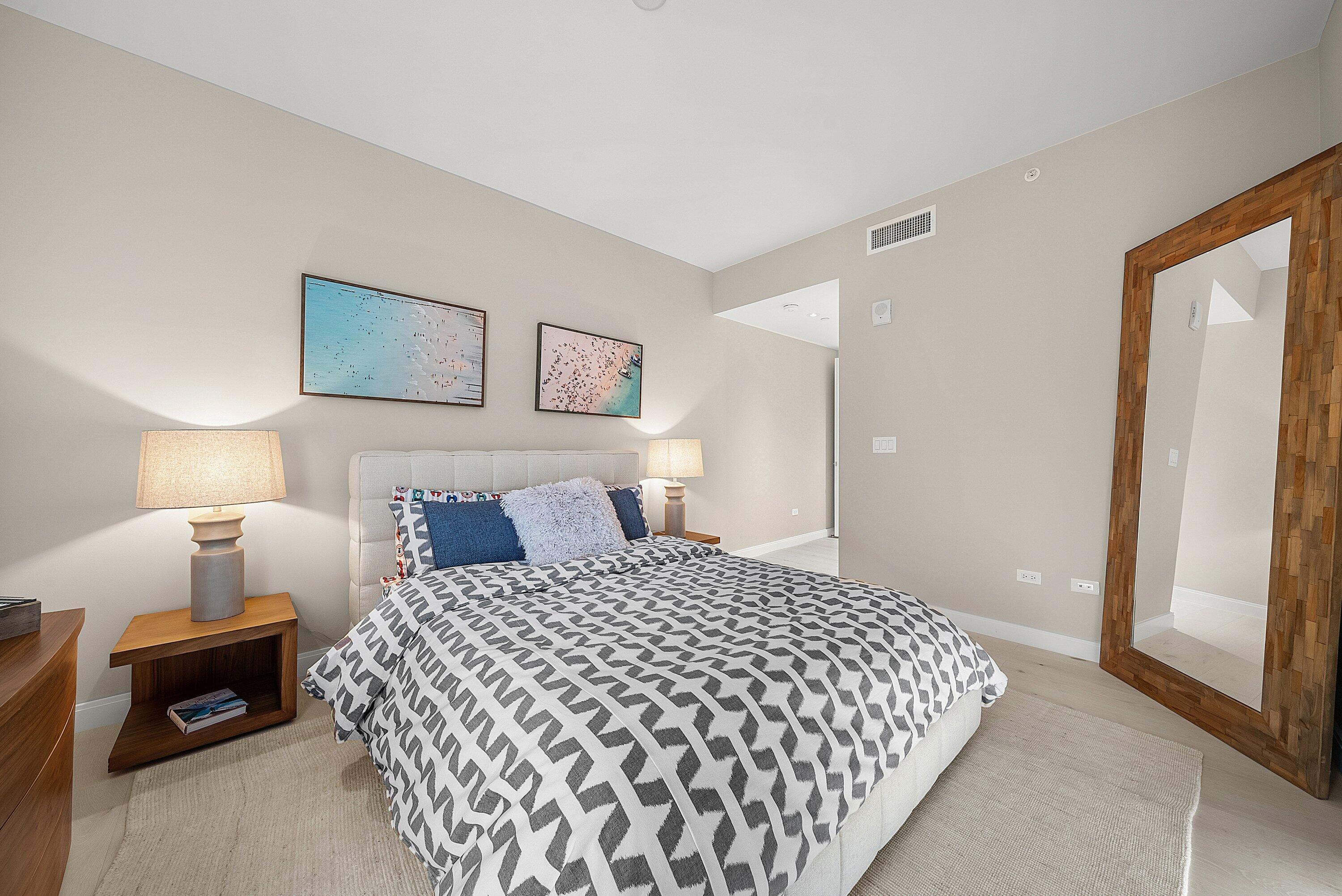 3550 South Ocean Boulevard, Unit 7C South Palm Beach, FL 33480 - Photo 27 of 66 a bedroom with a bed and a lamp