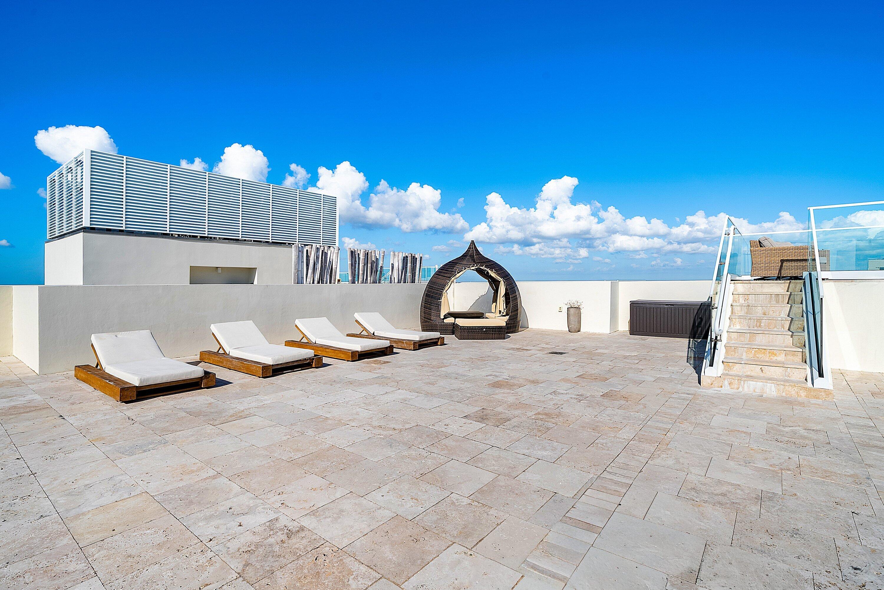 3550 South Ocean Boulevard, Unit 7C South Palm Beach, FL 33480 - Photo 41 of 66 a view of a terrace with a table and chairs