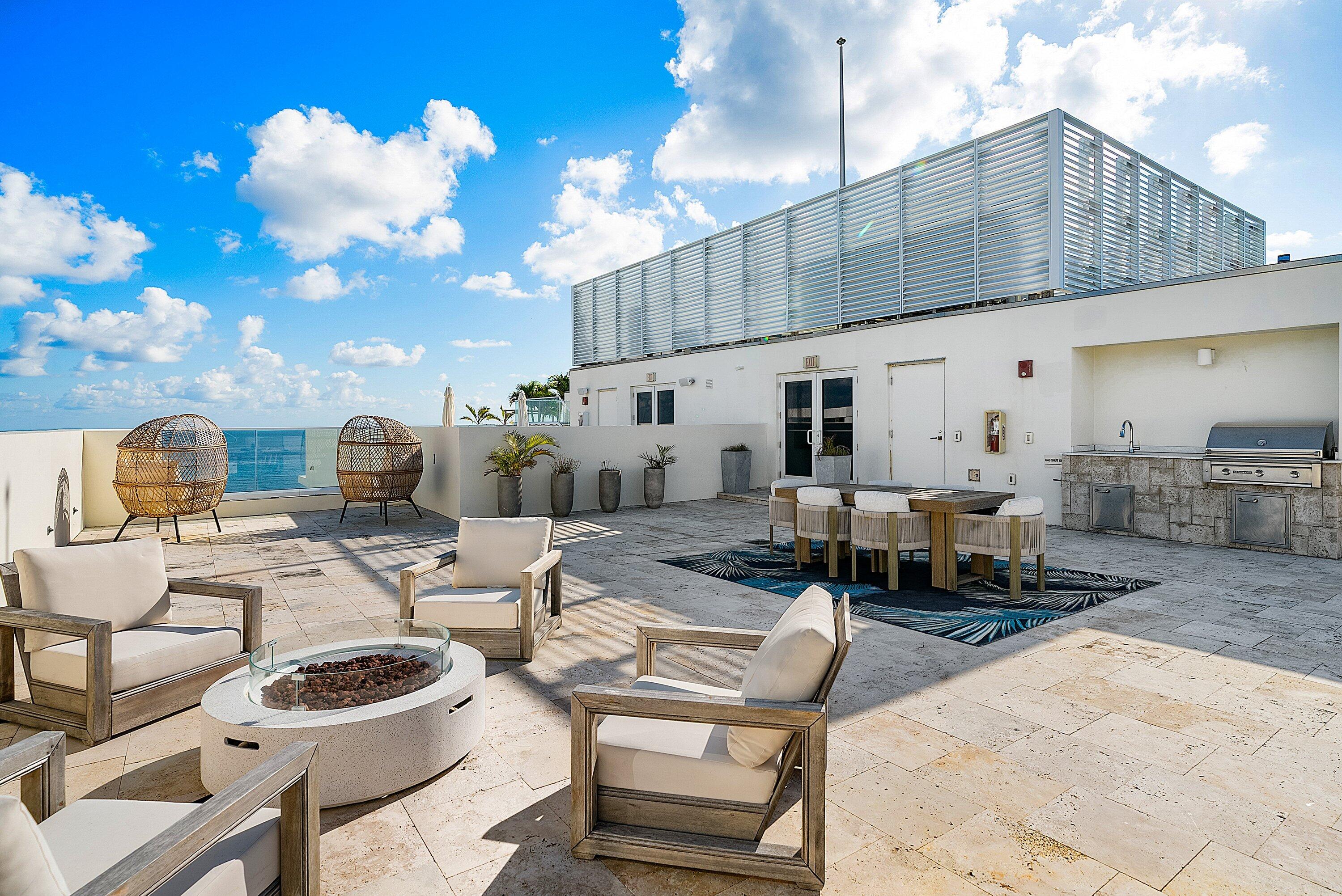 3550 South Ocean Boulevard, Unit 7C South Palm Beach, FL 33480 - Photo 42 of 66 a building outdoor space with patio furniture and potted plants