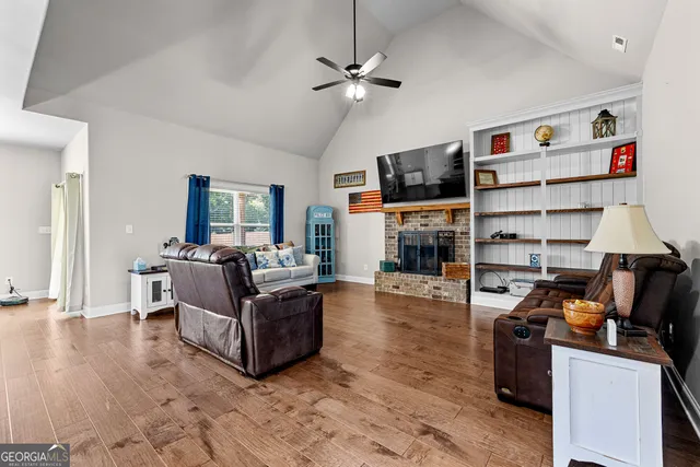 a living room with furniture and a fireplace