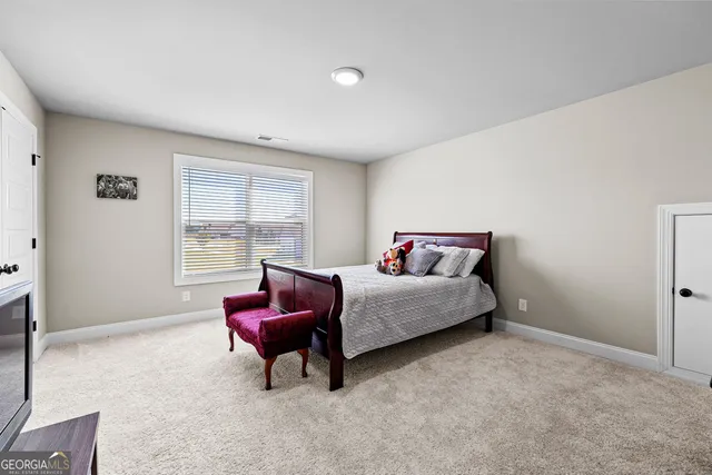 a bedroom with a bed and glass windows