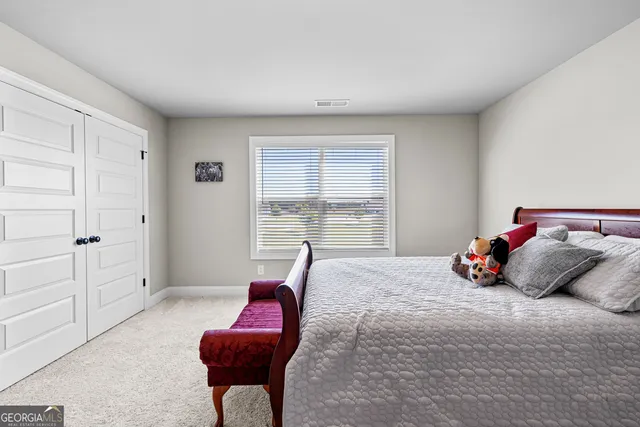 a bedroom with a bed and a couch