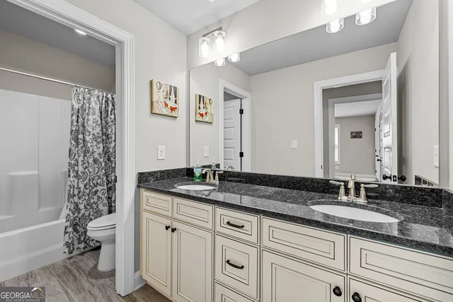 a bathroom with a shower curtain and a toilet