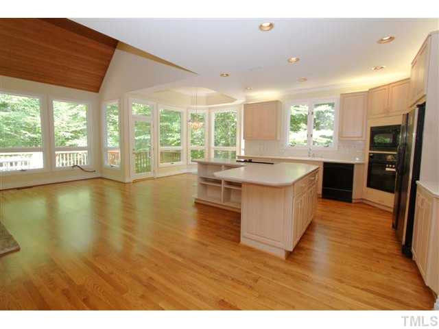 1433 Adams Mountain Road Raleigh, NC 27614 - Photo 7 of 25 a large kitchen with stainless steel appliances granite countertop a large counter top a stove and a wooden floors
