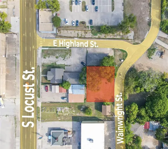 an aerial view of a residential building with an outdoor space