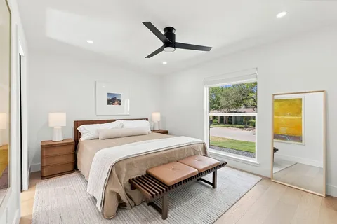 a bedroom with a bed and flat screen tv