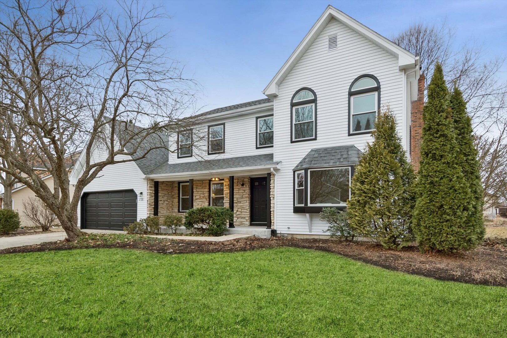731 South River Road Naperville, IL 60540 - Photo 1 of 27 a front view of a house with garden