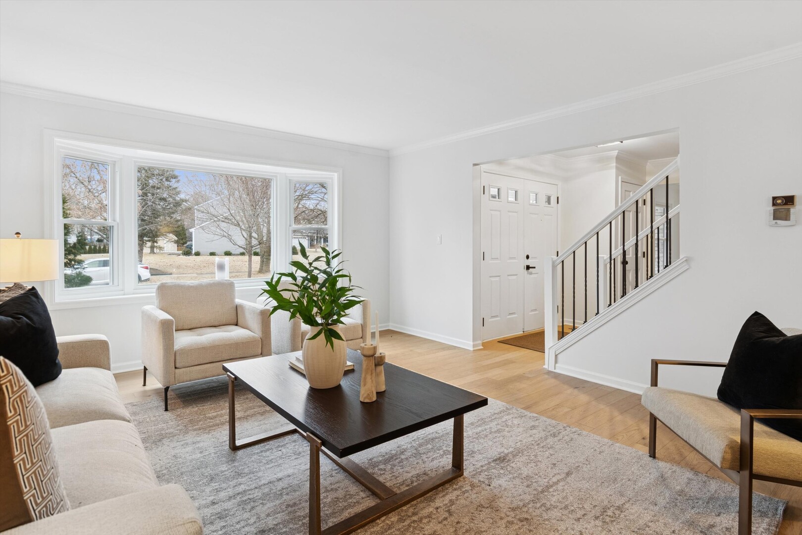 731 South River Road Naperville, IL 60540 - Photo 10 of 27 a living room with furniture a table and a potted plant